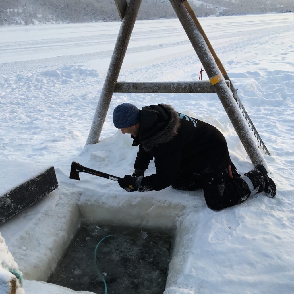 The ice hole (Finland) to put the trap into for Arctic King Crab is cut with a chainsaw. Later an axe is used to chip away were needed.