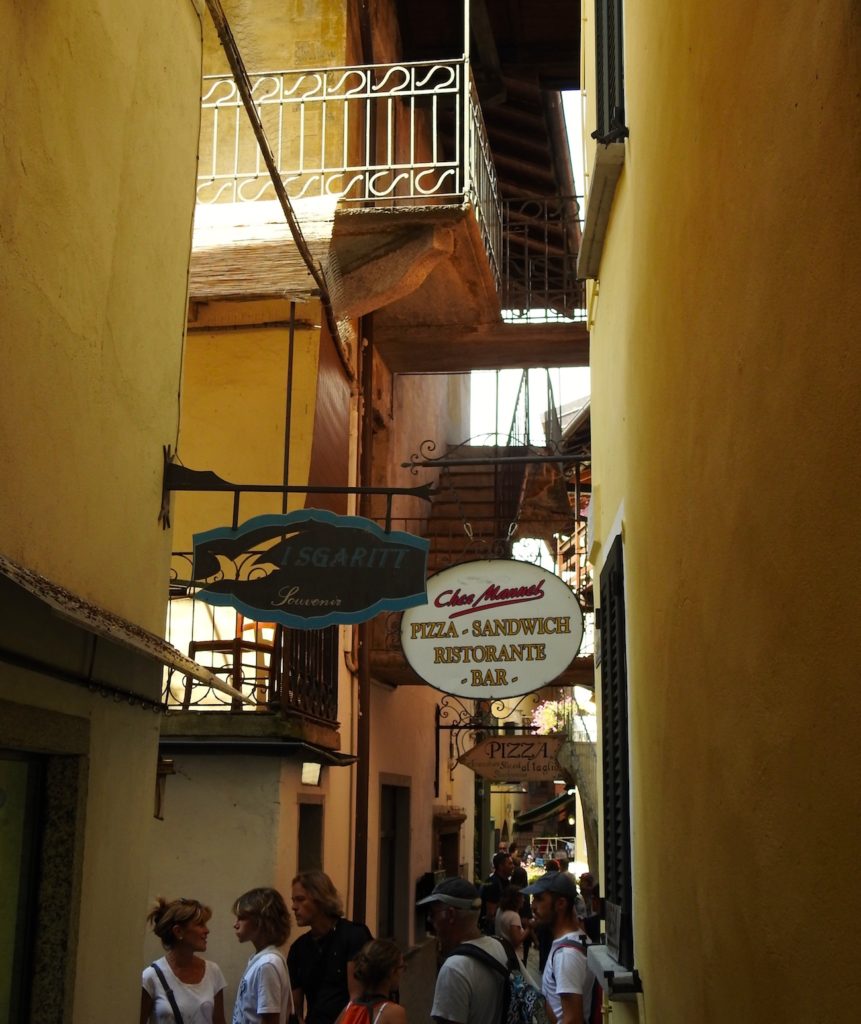 Alleyway at Fisherman's Island with many cafes and restaurants offering a variety of menus. Lake Maggiore, northern Italy. www.gypsyat60.com