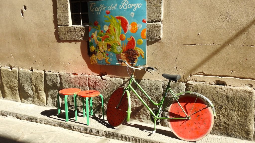 Bike in alleyway of Lucca with watermelon wheels. www.gypsyat60.com