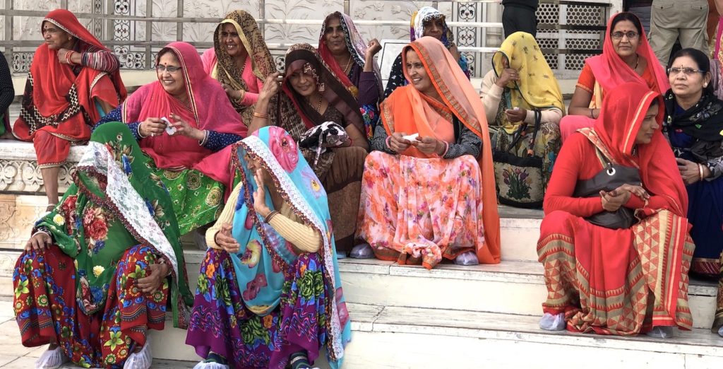 Colourful Indian ladies, dressed in their saris, on steps of Taj Mahal. www.gypsyat60.com
