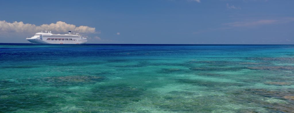 photo of Dawn Princess in brilliant blue waters surrounding Kitava Island, PNG. www.gypsyat60.com